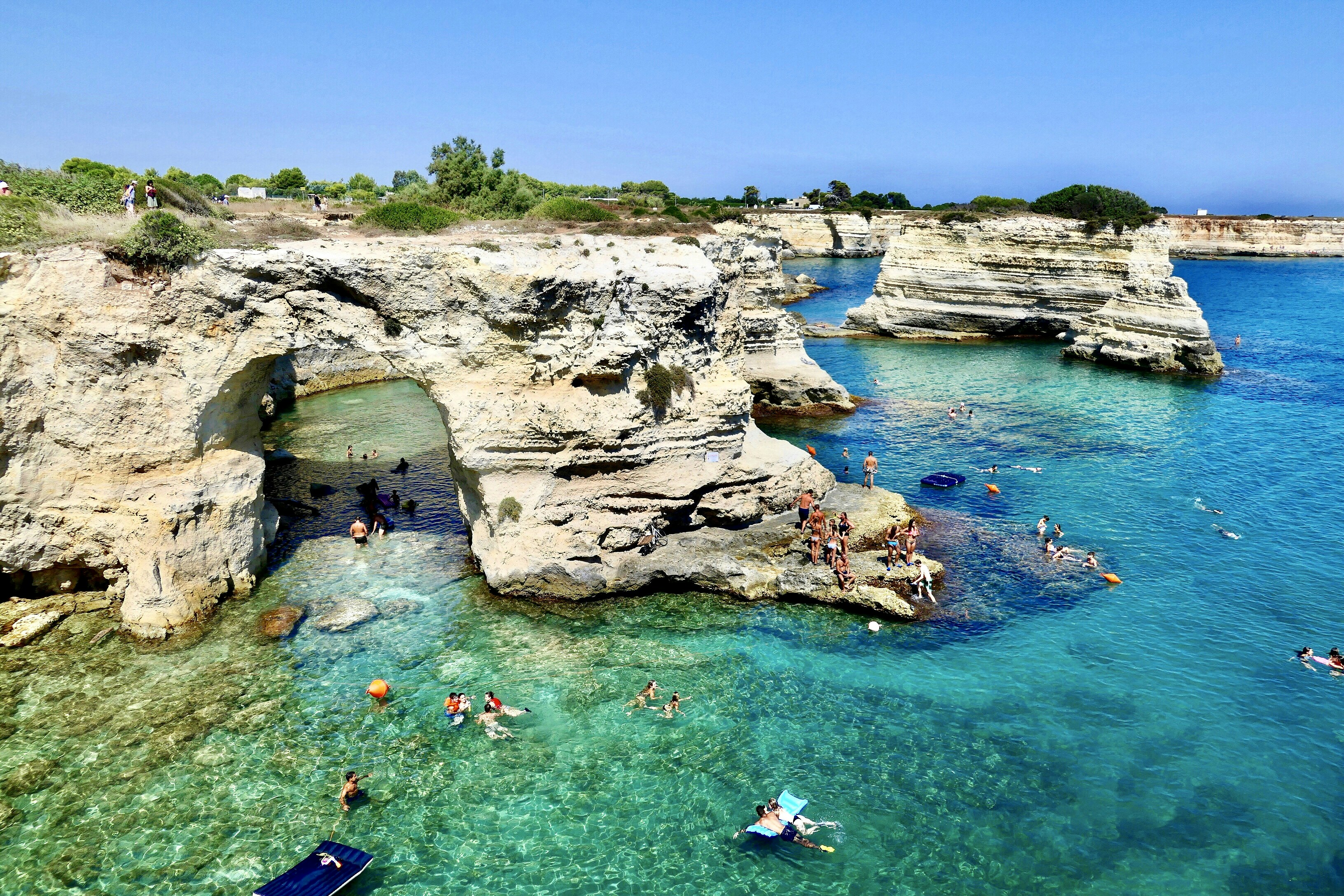 people swimming on sea during daytime, Faraglioni di Torre Sant’Andrea 