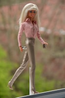 High-definition image of a Barbie doll set featuring a beach outfit and matching accessories displayed neatly.