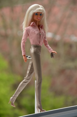 High-definition image of a Barbie doll set featuring a beach outfit and matching accessories displayed neatly.