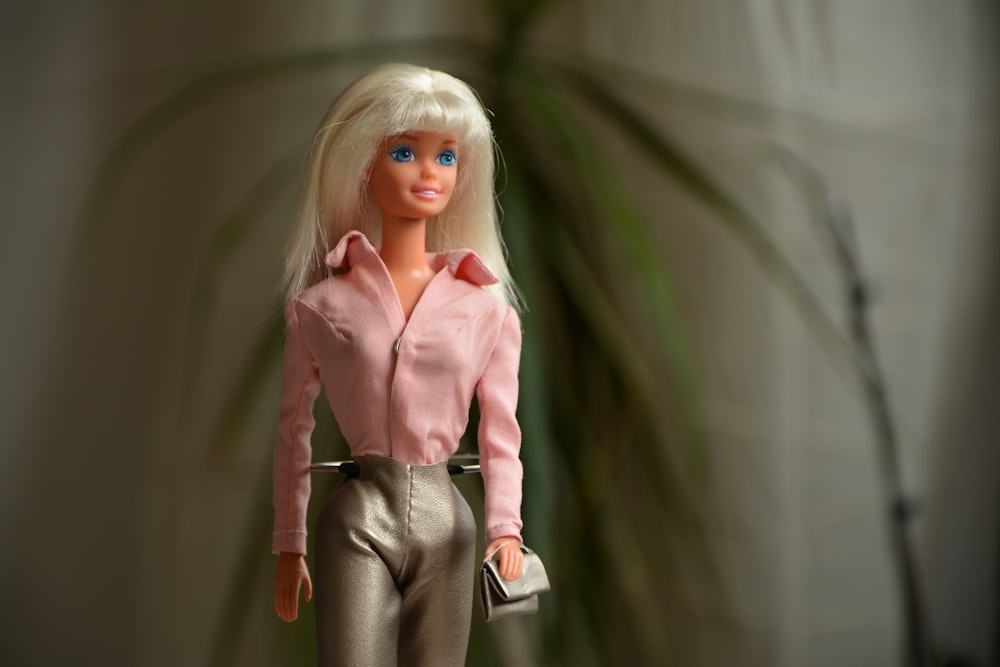 woman in pink dress shirt and gray pants