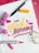 A colorful, artistic arrangement features the phrase 'Your artwork is stunning' in vibrant lettering. The words are surrounded by markers, one with a yellow tip and another with a pink tip. Accents include small floral elements, both pink flowers and white delicate sprigs, adding a decorative touch to the scene.