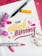 A colorful, artistic arrangement features the phrase 'Your artwork is stunning' in vibrant lettering. The words are surrounded by markers, one with a yellow tip and another with a pink tip. Accents include small floral elements, both pink flowers and white delicate sprigs, adding a decorative touch to the scene.
