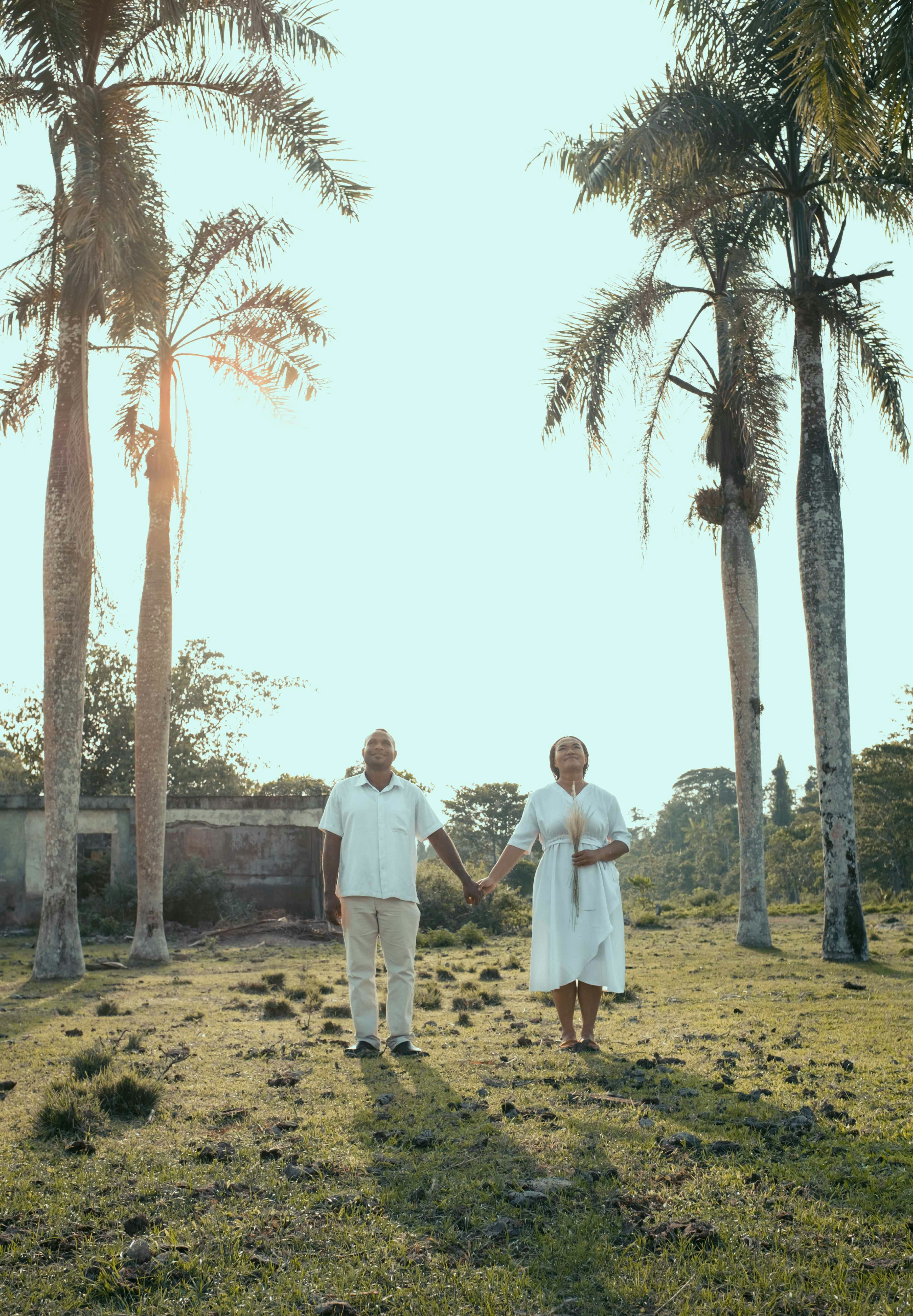 man in white dress shirt standing beside woman in white dress