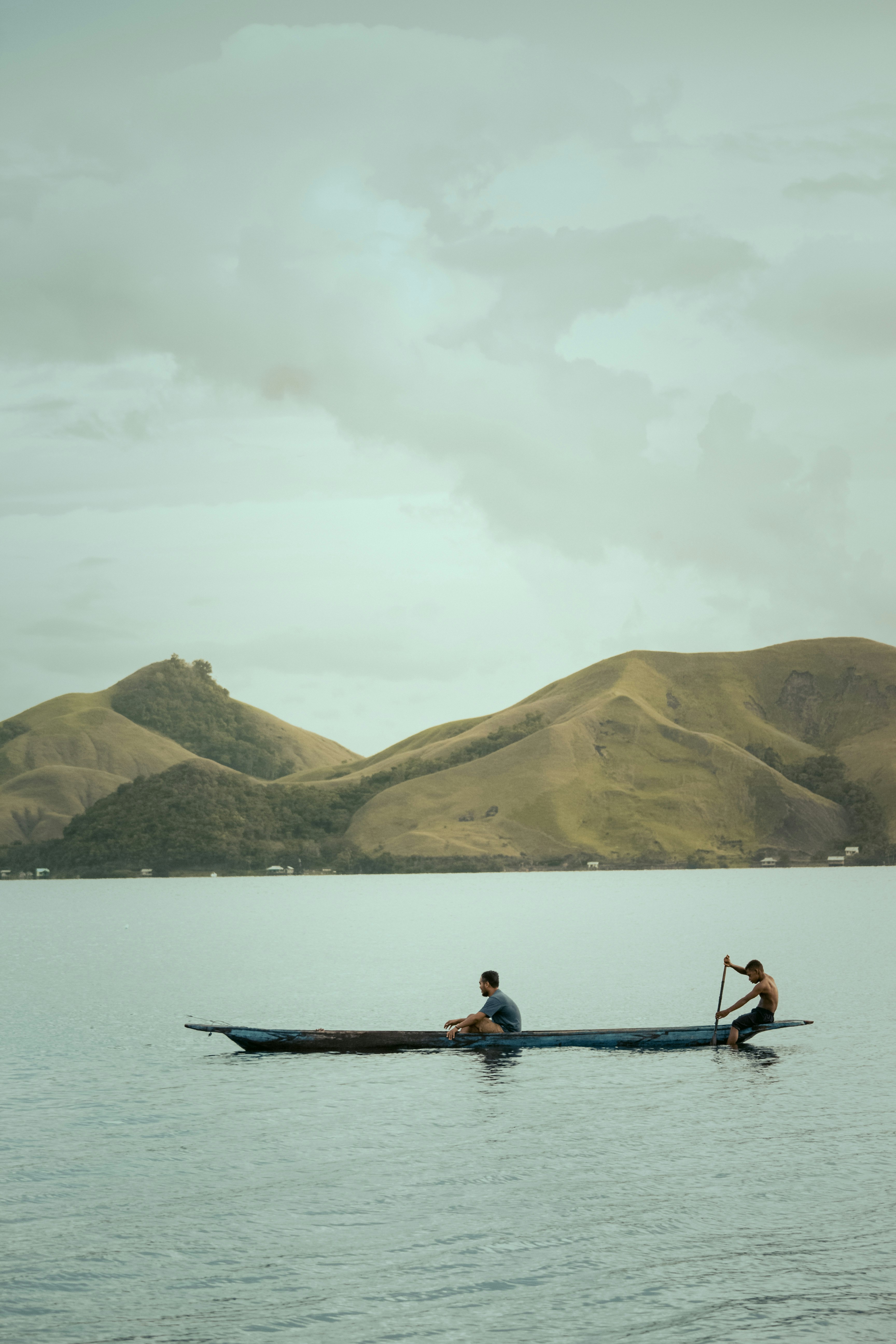 2 person riding on boat on body of water during daytime