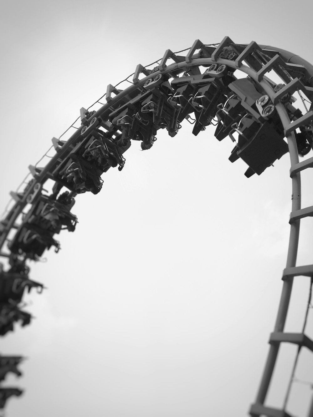 a black and white photo of a roller coaster