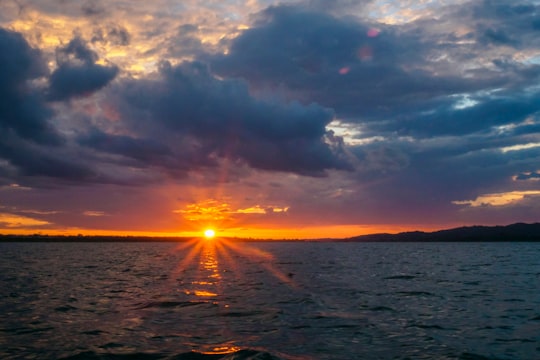 body of water under cloudy sky during sunset in El Petén Guatemala