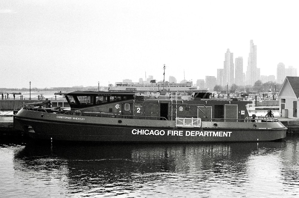 grayscale photo of a boat on a river