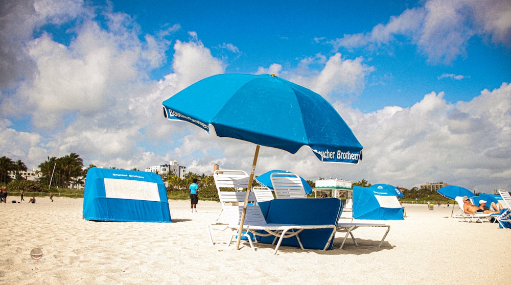 blue and white beach umbrellas on beach during daytime