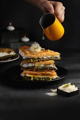 burger with egg on black plate