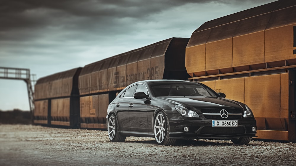 Silbernes Mercedes Benz Coupé parkt in der Nähe von Brown Building