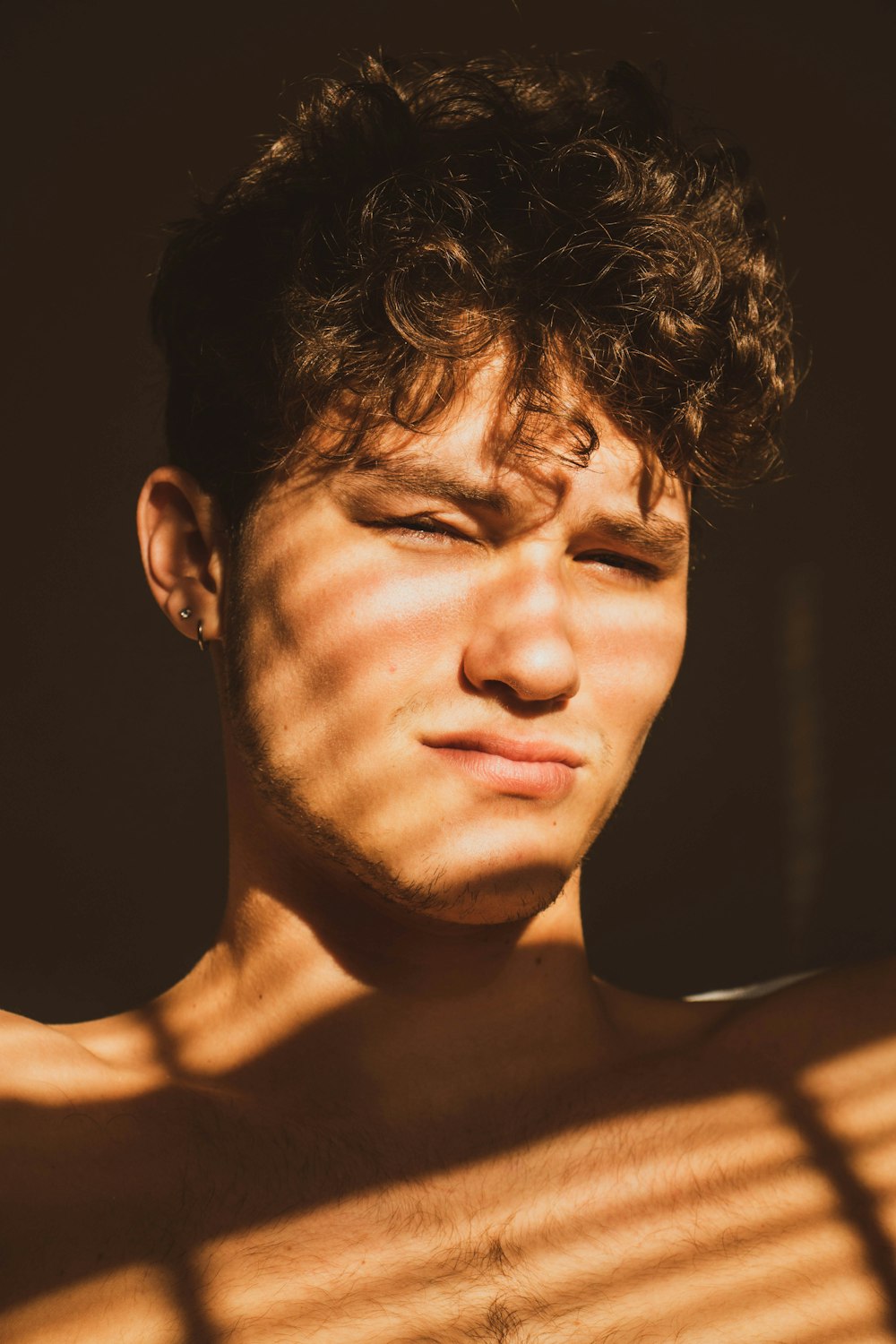 topless man with black background