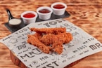 fried chicken on brown wooden chopping board