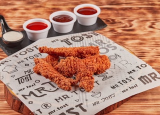 fried chicken on brown wooden chopping board