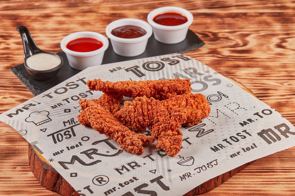 fried chicken on brown wooden chopping board