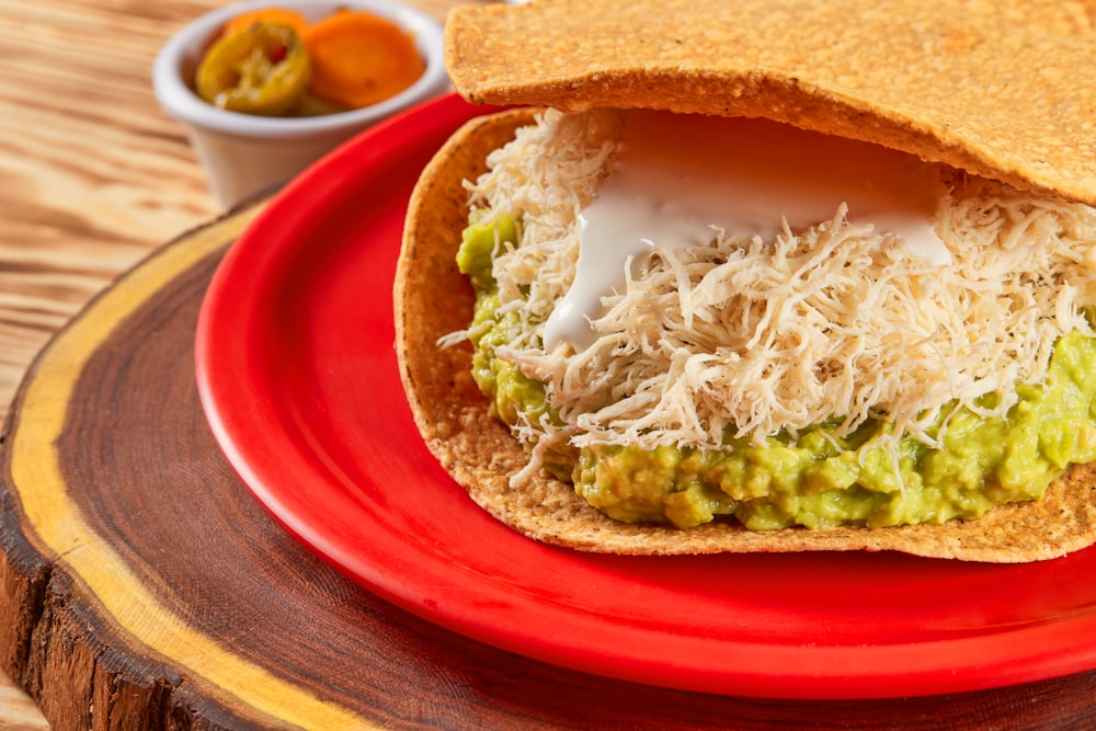 brown bread with green vegetable on red plate