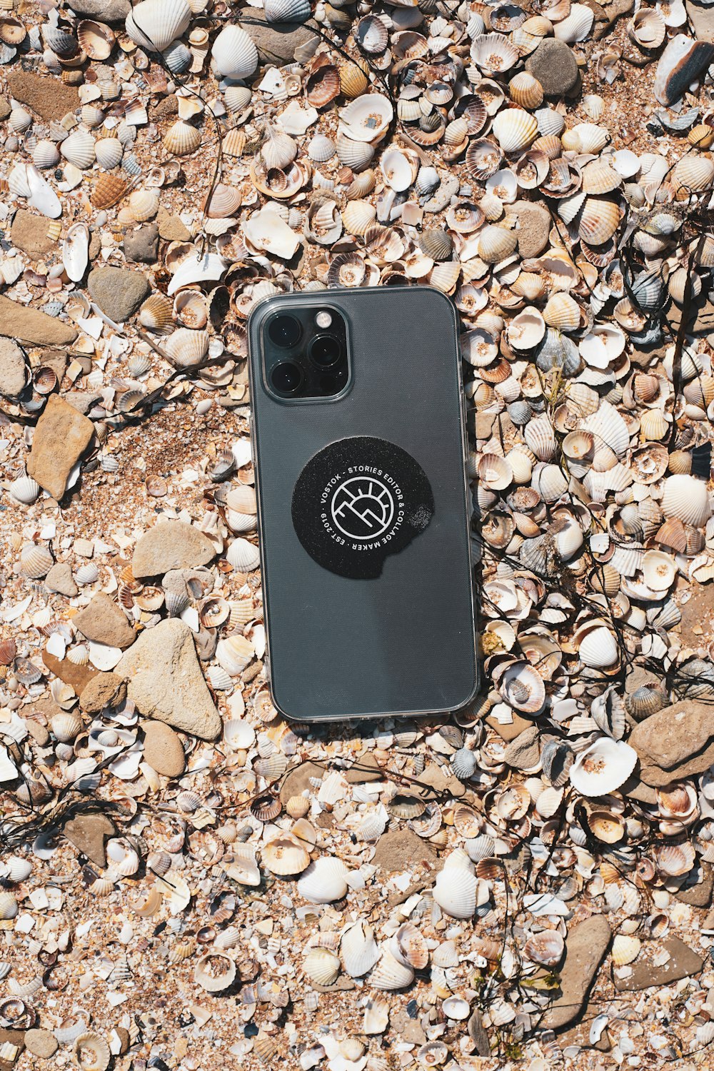 black and white iphone case on brown and gray stones