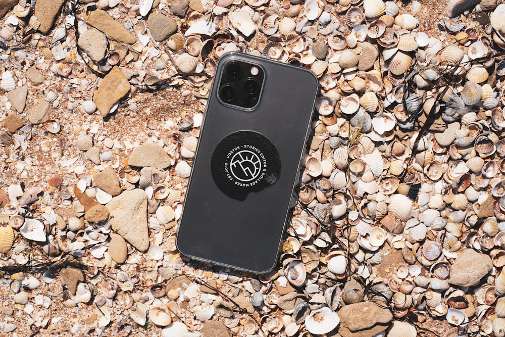 black iphone case on brown and gray stones