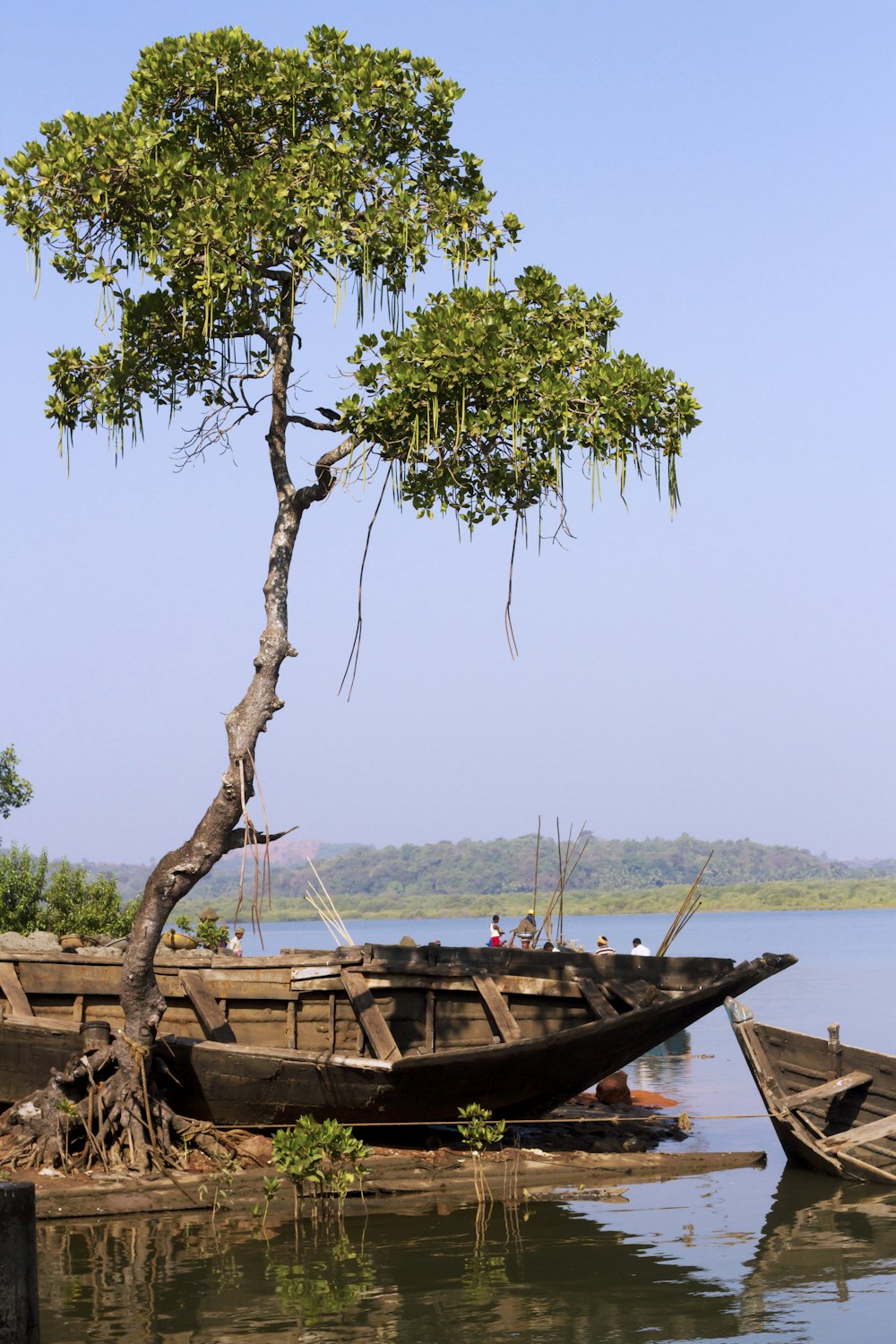 brown wooden boat on body of water during daytime