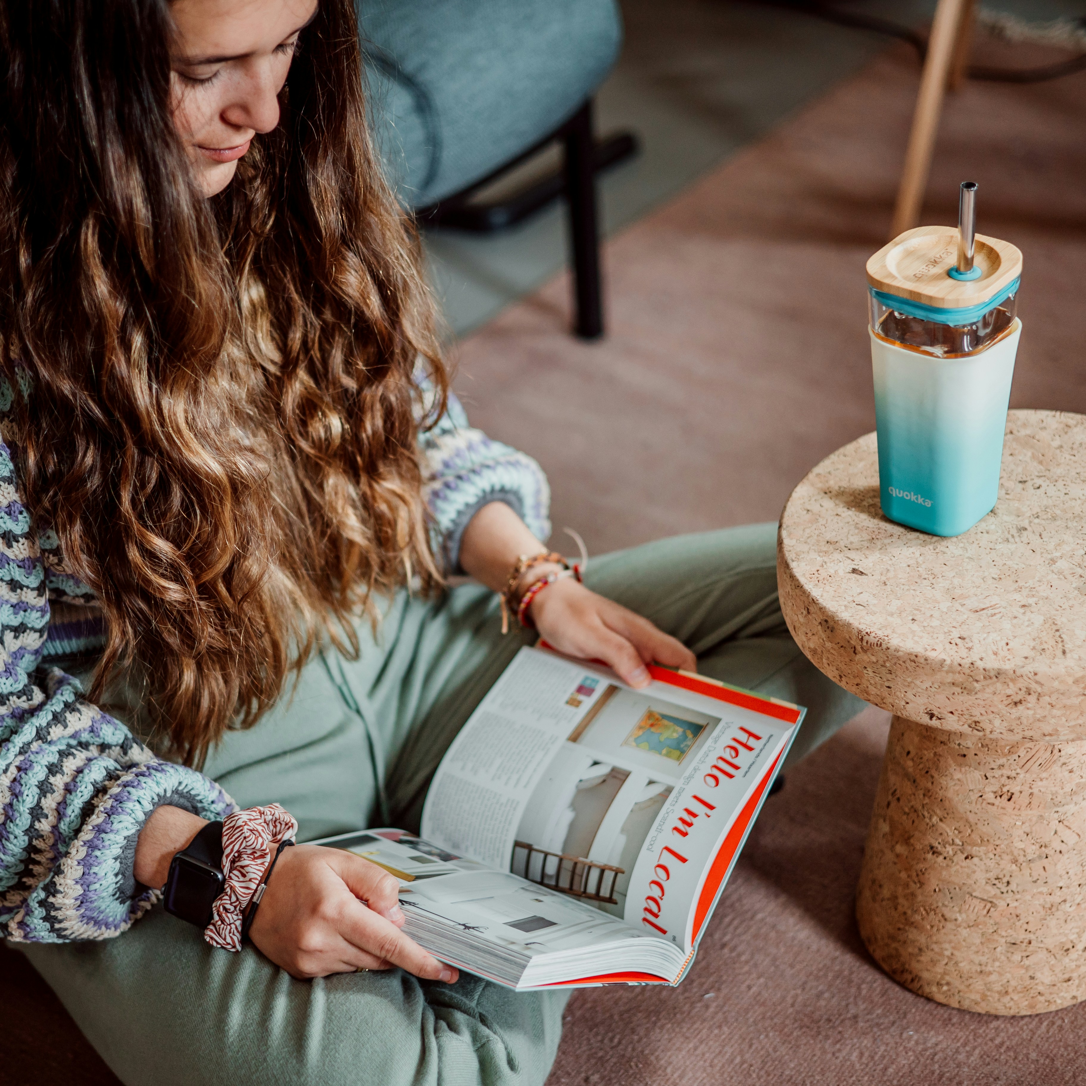 woman in white sweater reading newspaper