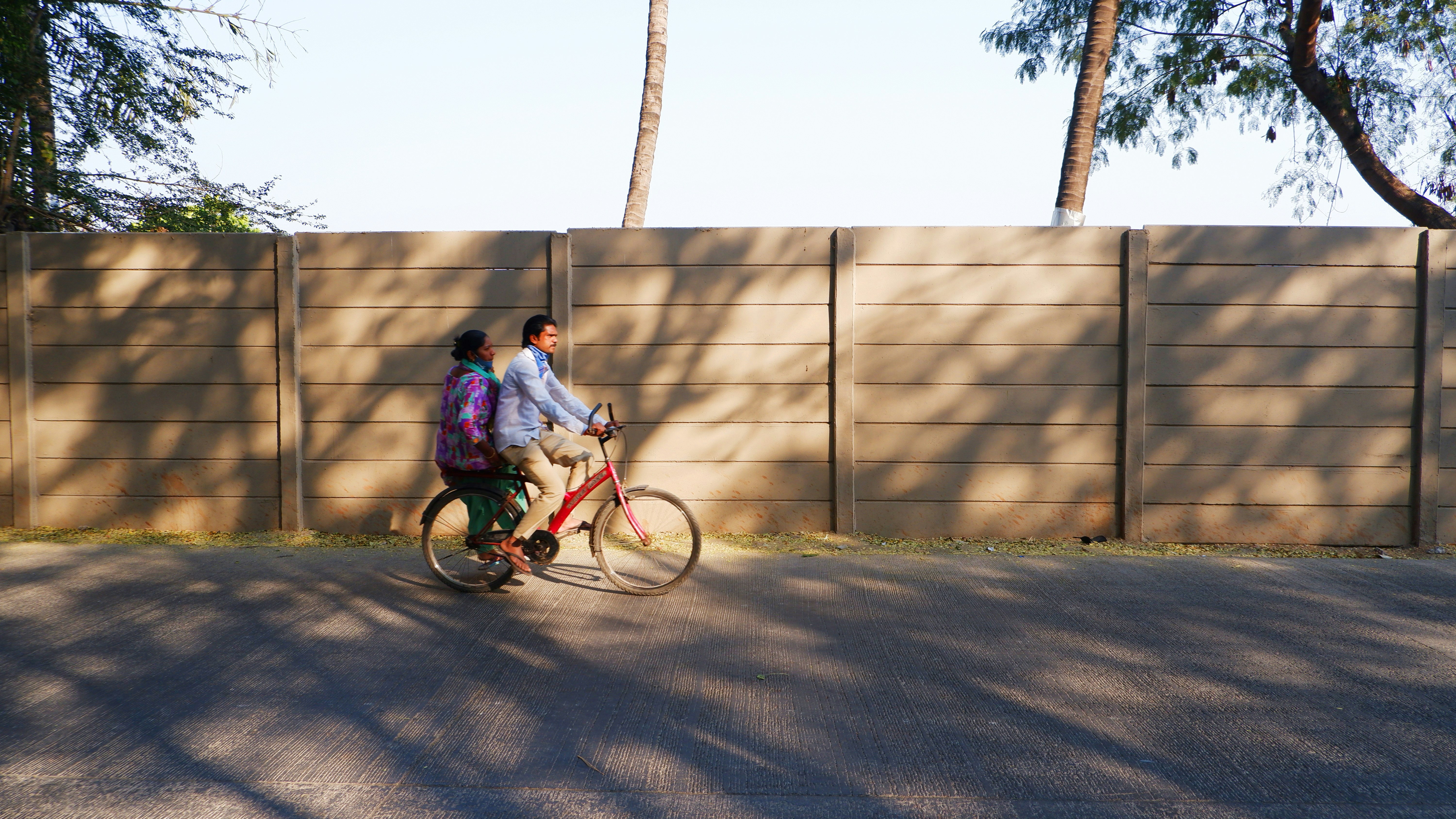 man in blue jacket riding on bicycle during daytime