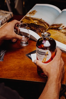 person holding white labeled bottle