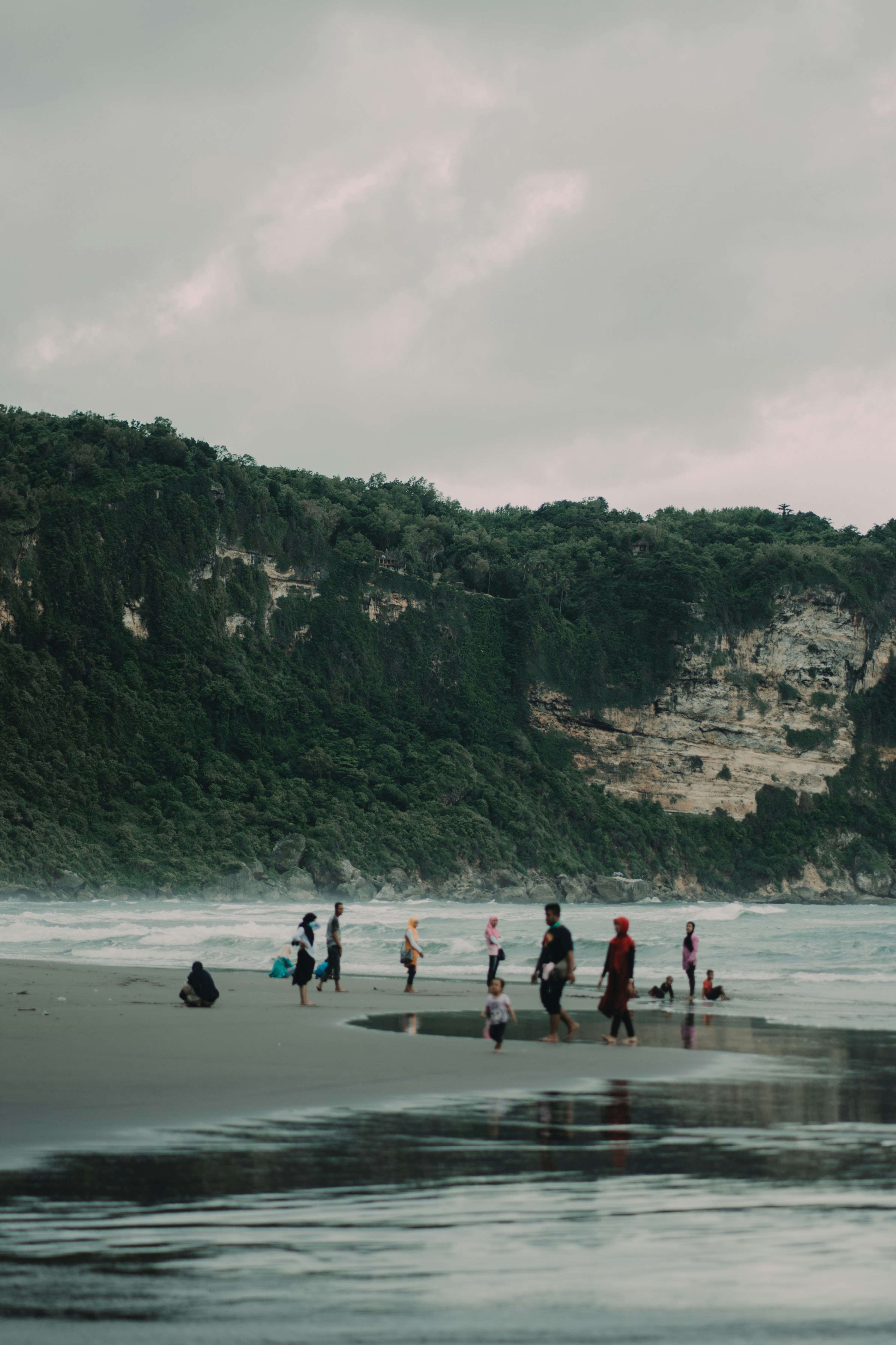 people walking on beach shore during daytime