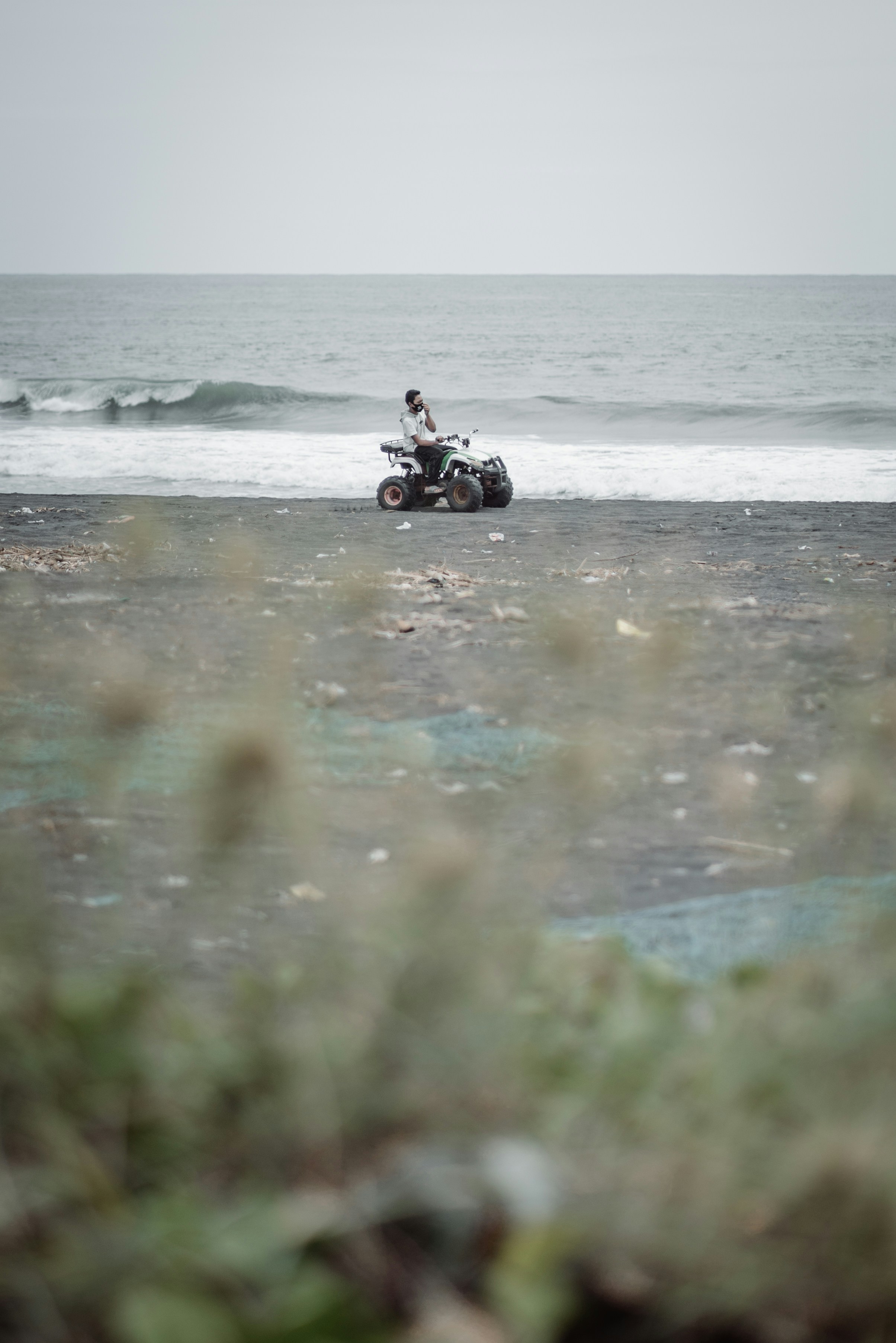 person riding on black atv on water during daytime