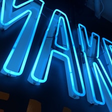 A collection of colorful neon letters and shapes arranged artistically on a wall.