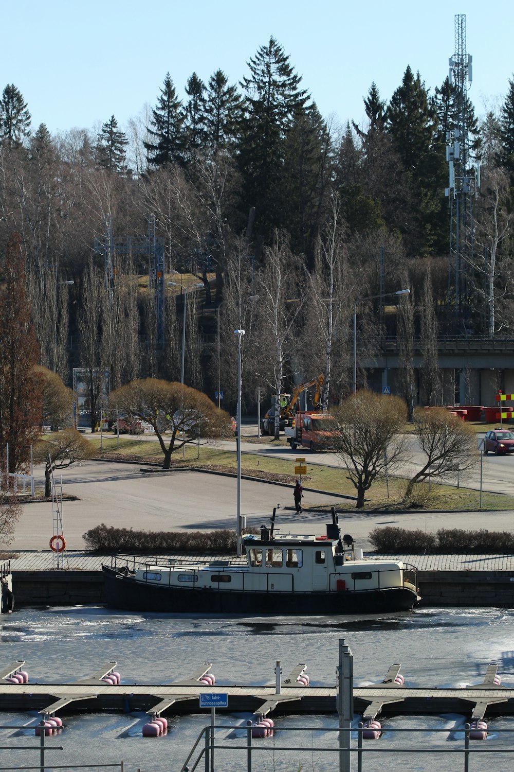 white boat on body of water near trees during daytime