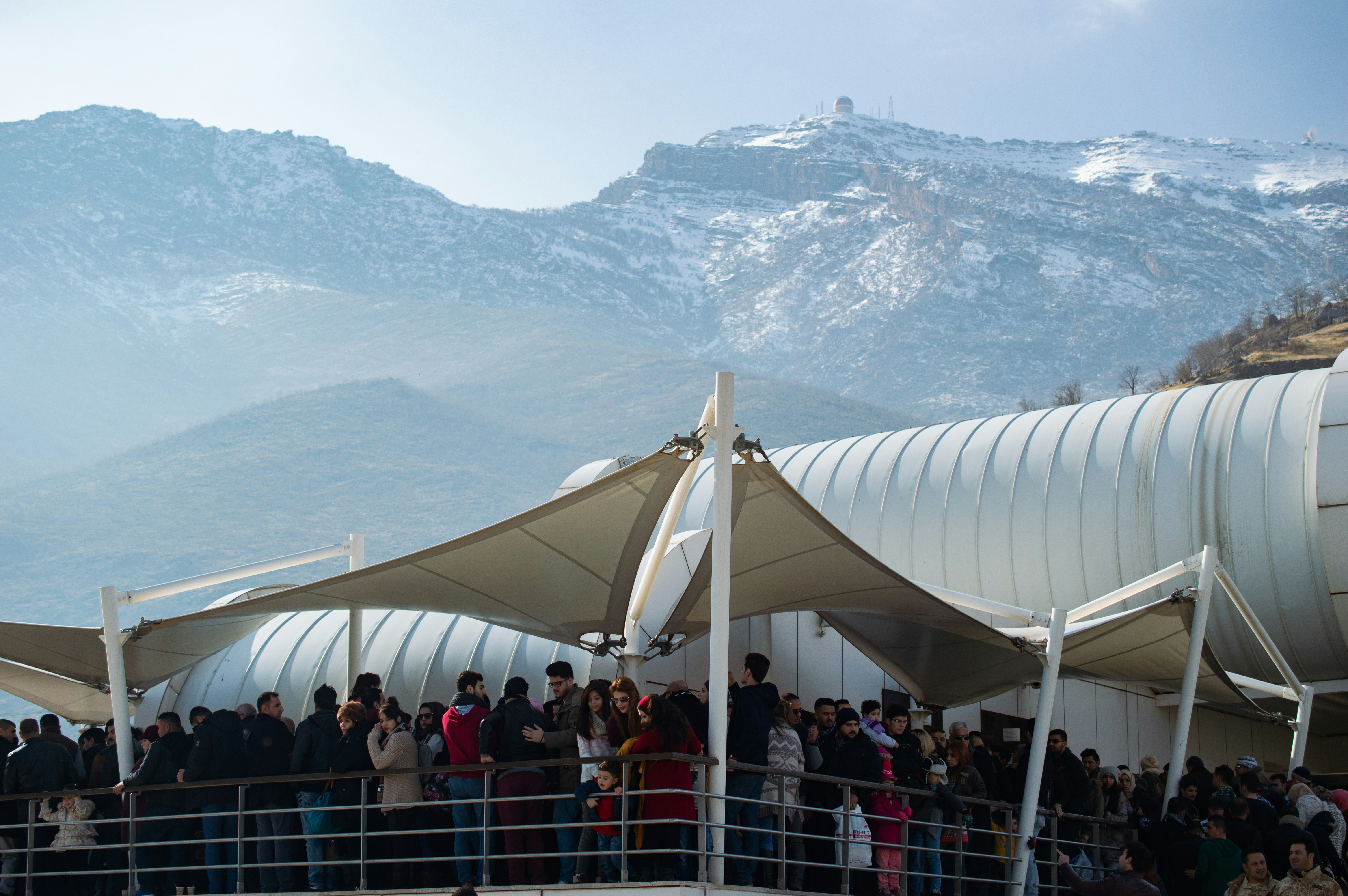 people standing on white canopy tent during daytime