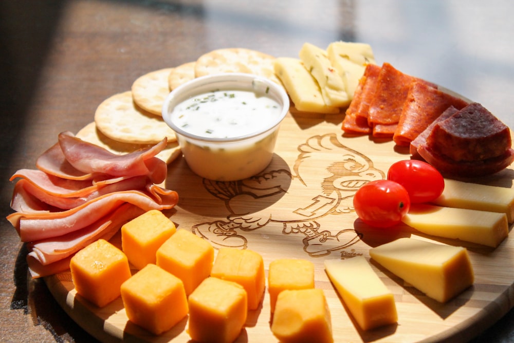 sliced cheese and red tomato beside white ceramic bowl with milk