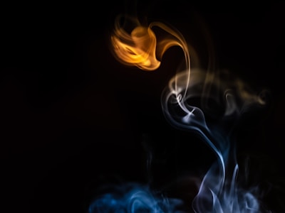 Smoke swirling around glowing embers from a recently exploded firework.