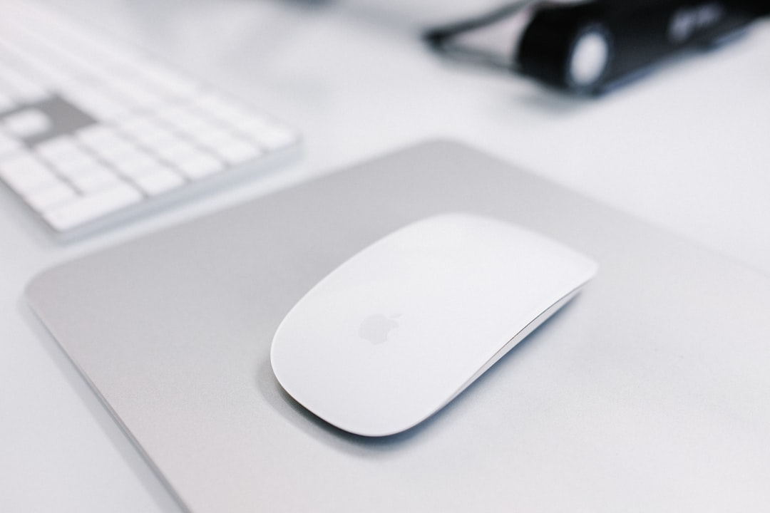 apple magic mouse on white table