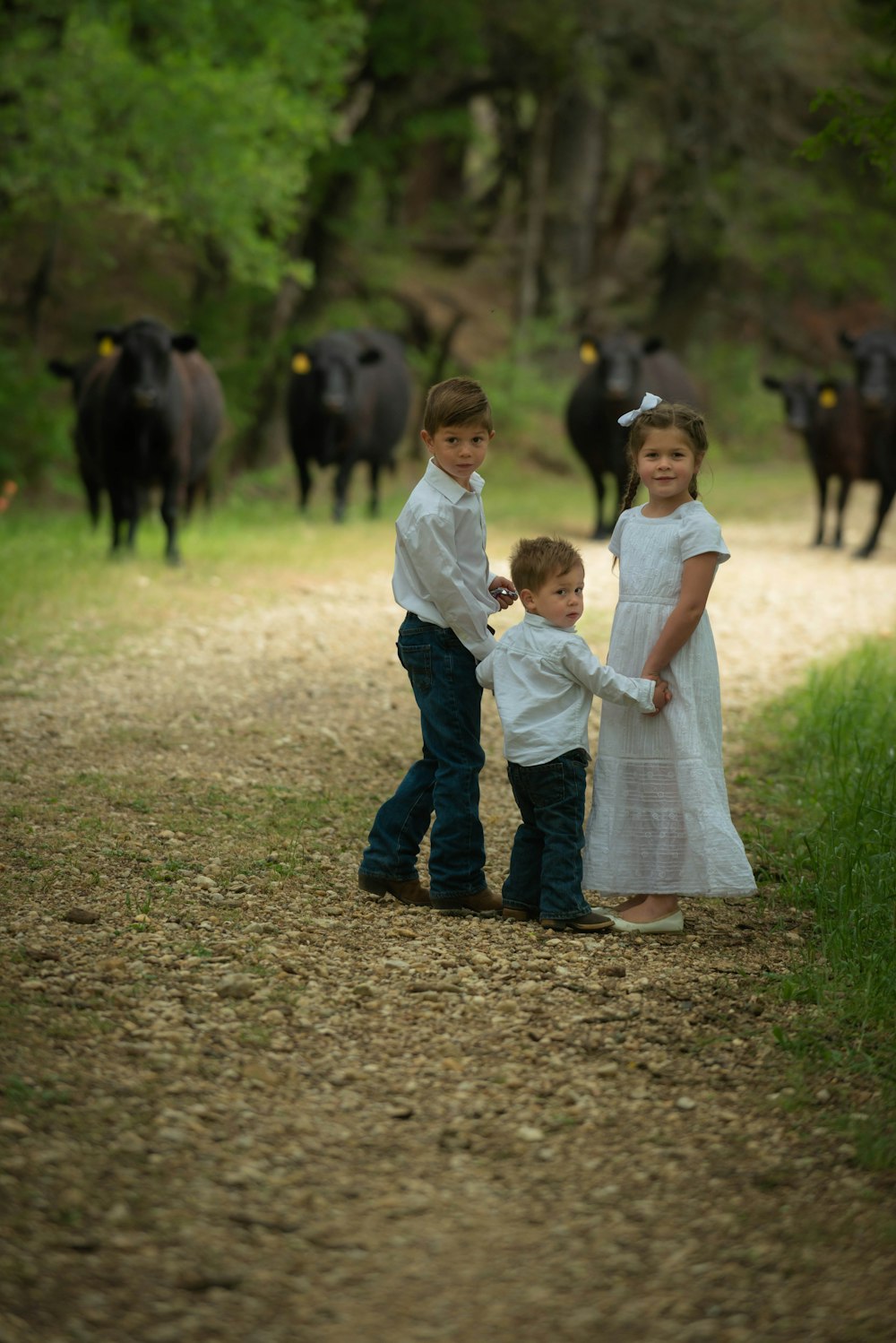 girl in white dress holding hands with girl in white dress