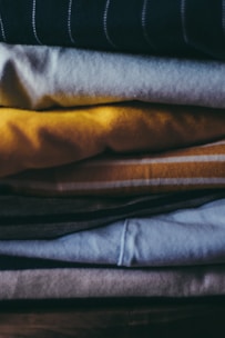 A close-up of freshly laundered clothes neatly folded and stacked.
