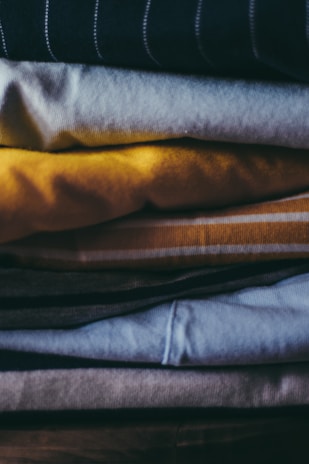 A close-up of freshly folded clothes stacked neatly.