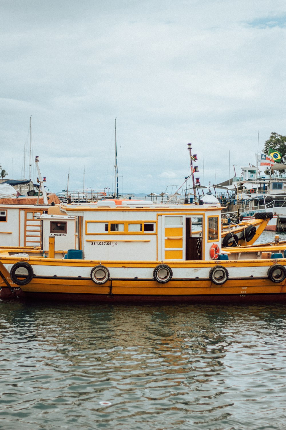 yellow and white boat on water during daytime