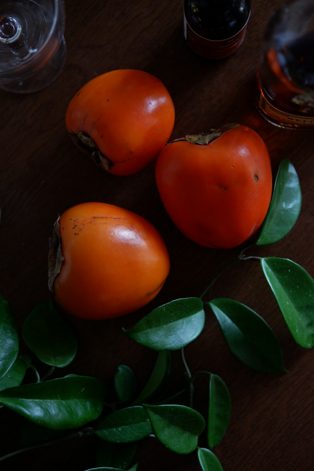 orange tomato on brown wooden table