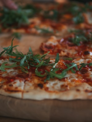 A close-up of a freshly baked pizza topped with vibrant ingredients.