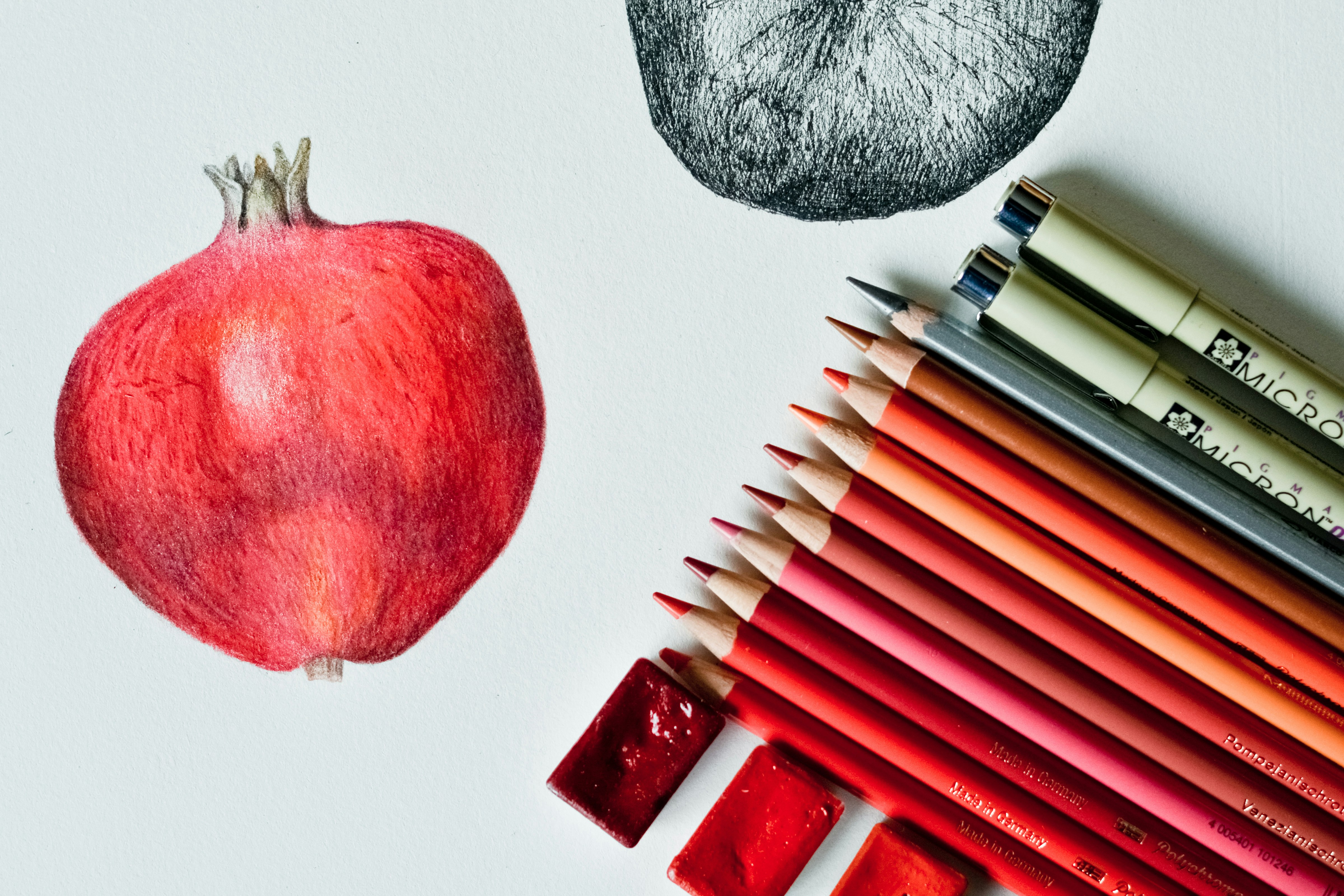 red apple fruit beside black and white pen