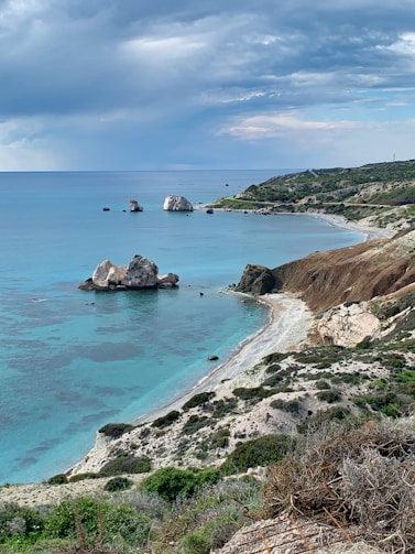 brown rock formation on blue sea under blue sky during daytime