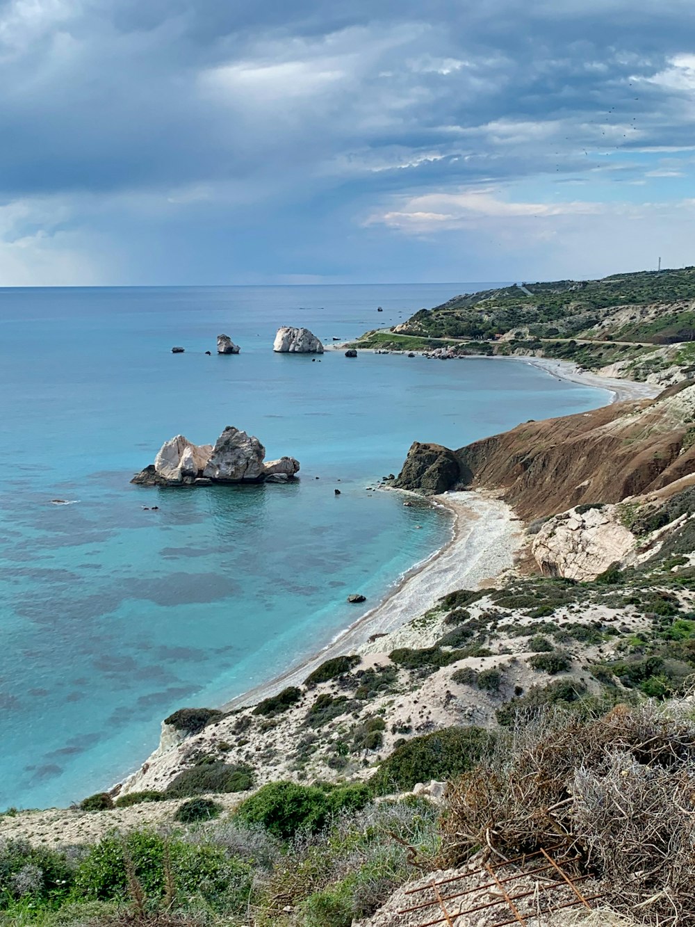 brown rock formation on blue sea under blue sky during daytime