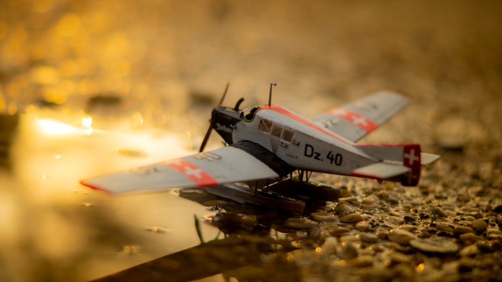 white and red jet plane on brown ground