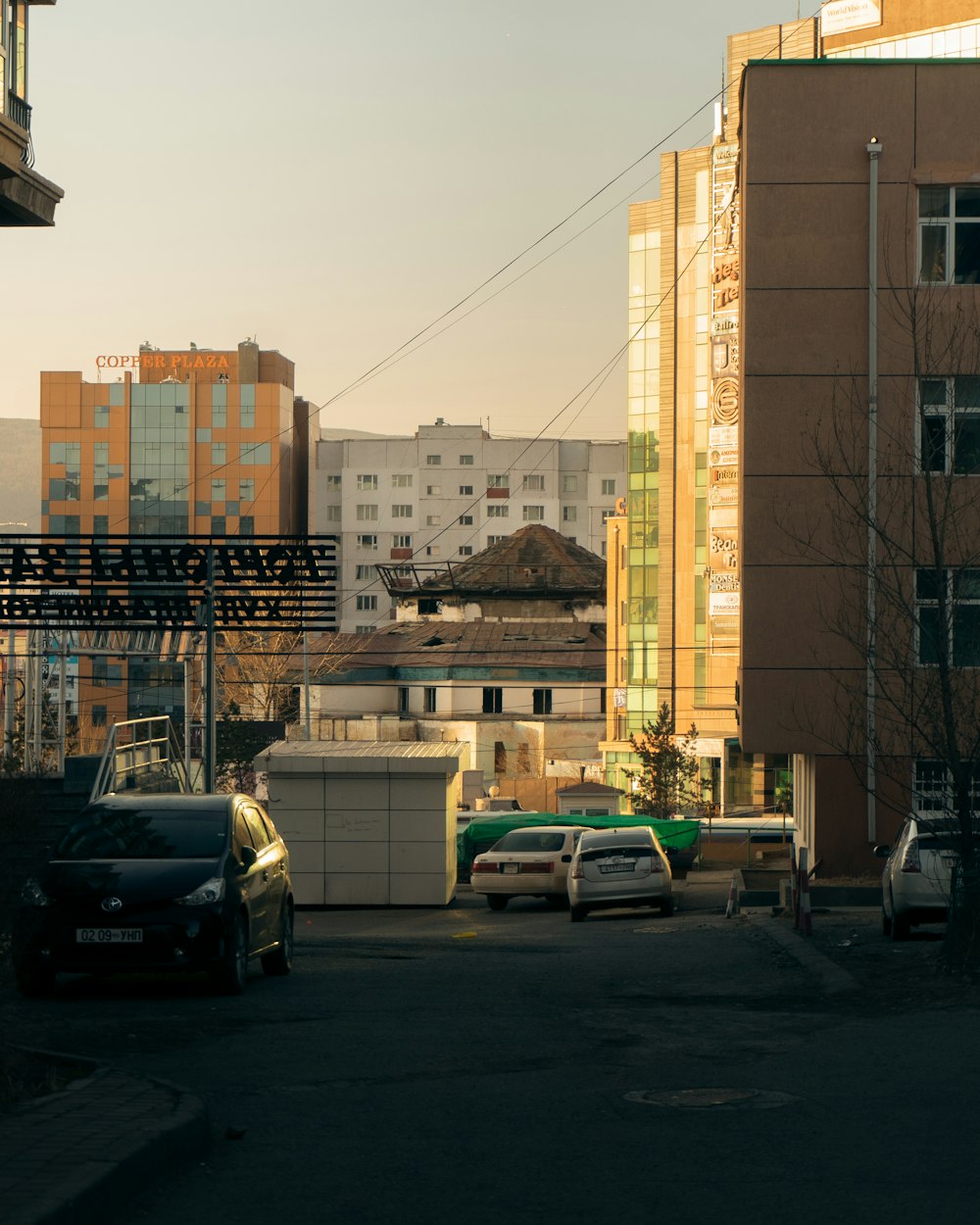 cars parked on parking lot near building during daytime