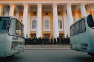 A team of uniformed Protebek security personnel standing ready in front of a corporate office.