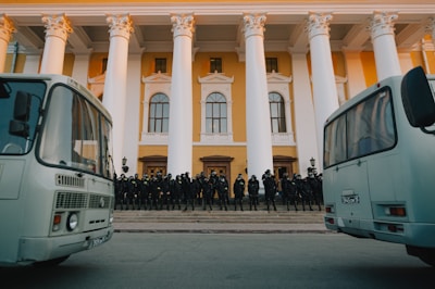 A team of uniformed security guards standing confidently outside a corporate building.