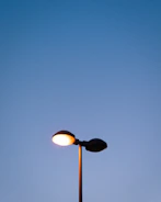 A glowing lamppost at dusk symbolizing guidance and innovation.