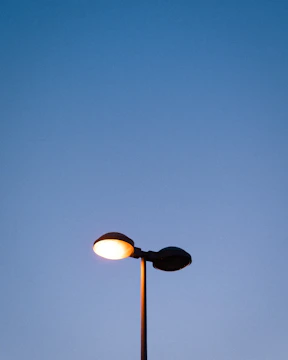 A glowing lamppost at dusk symbolizing guidance and innovation.