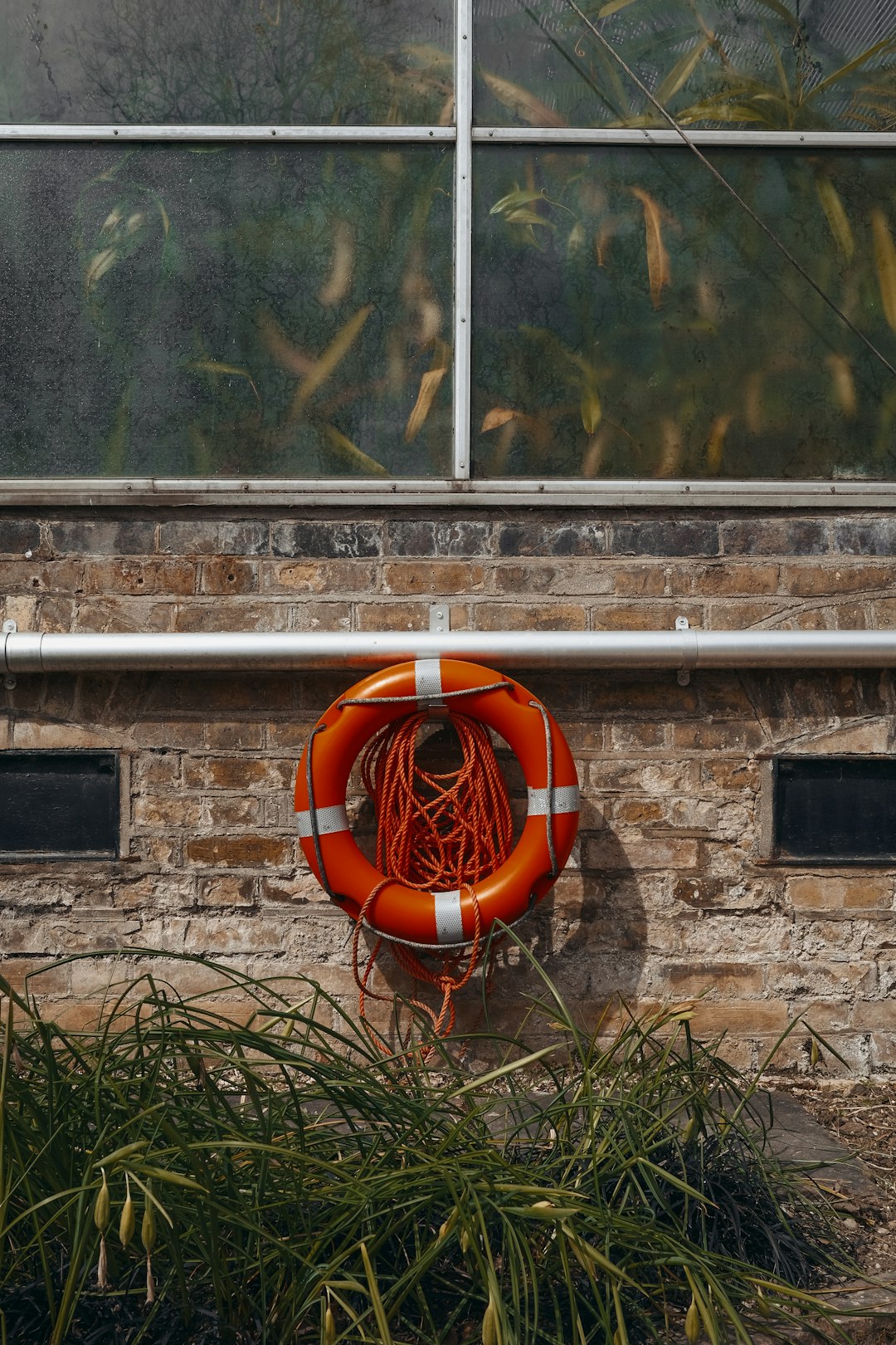 orange and white inflatable ring on brown brick wall