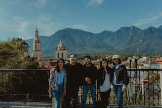 A diverse group of travelers enjoying a scenic mountain view together.